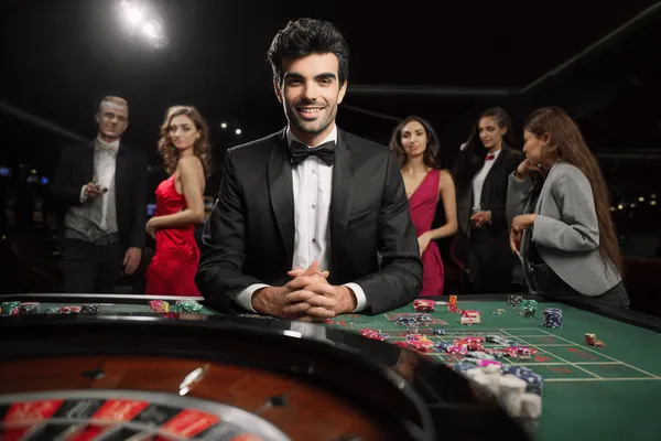 A glamorous woman holding casino chips in a neon-lit environment, representing the premium online casino atmosphere of 520JL.