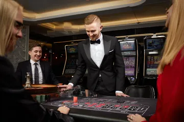 A stylish woman beside vibrant slot machines displaying glowing sevens, showcasing the variety of top slots at 520JL.
